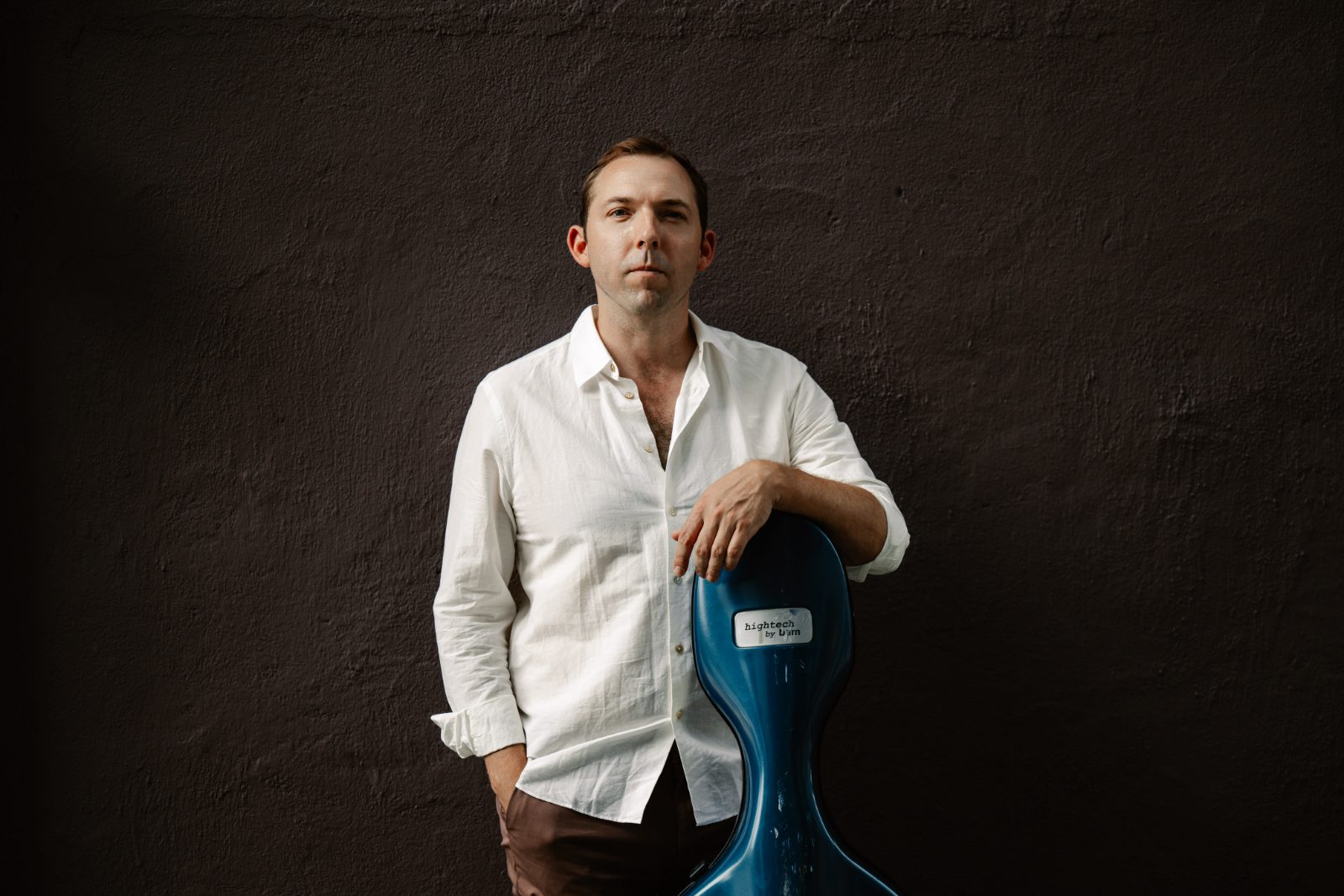 Brook Speltz with his cello in an urban setting.